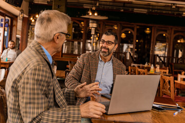 Having a discussion about the project in the cafe while smiling