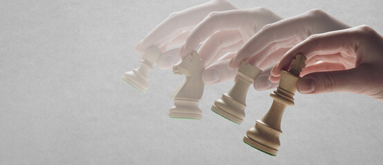 Chess player hand holding pieces