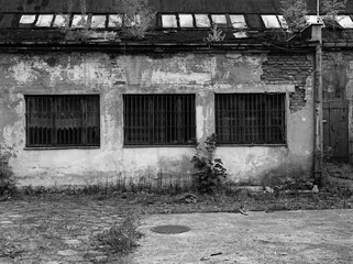 black and white photo of a ruined building. Photo of a building with three windows