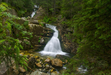 Fototapeta premium Close up view waterfall in deep forest at National Park. Waterfall in deep forest scene.