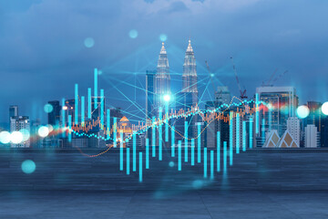 Rooftop with wooden terrace, Kuala Lumpur night skyline. Forecasting and business modeling of financial markets hologram digital charts. City downtown. Double exposure.