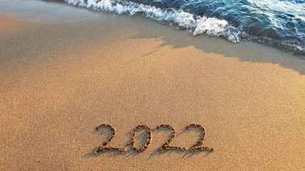 New Year 2022 is coming concept on tropical beach.