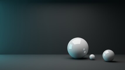 3D rendering of three different sized shiny white spheres in the front right image area, which are illuminated turquoise and white from two directions in front of a black background