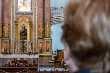 Unrecognizable woman from behind and out of focus, in a catholic church