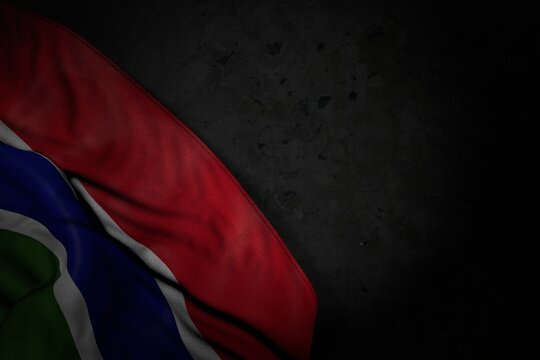 nice dark photo of Gambia flag with big folds on black stone with empty space for your content - any holiday flag 3d illustration..