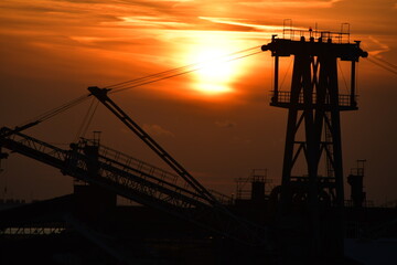 Sunset harbour - including cranes and other port machinery