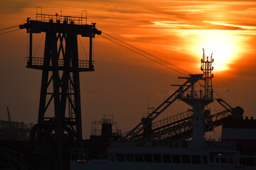 Sunset harbour - including cranes and other port machinery