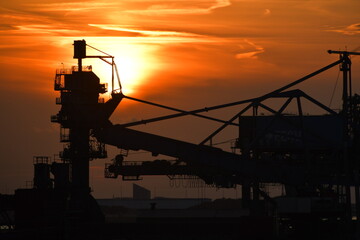 Sunset harbour - including cranes and other port machinery