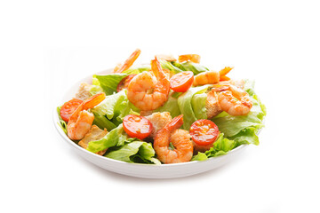 Salad with fresh leaves, shrimp, cherry tomatoes in a plate