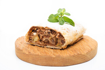 Traditional Viennese strudel with apples and raisins isolated on a white background