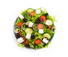 Greek salad with feta, olives, tomatoes and cucumbers isolated on a white background