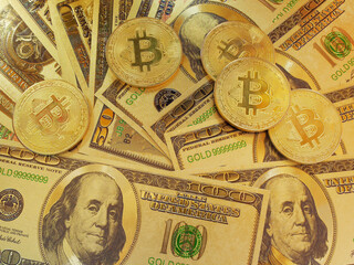 The bitcoins in form of coins on the banknotes of dollar