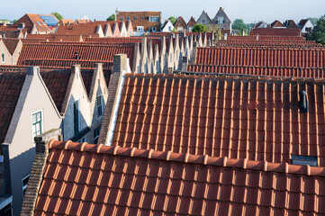 Walking in old Dutch town Zierikzee, red roofs of old small houses