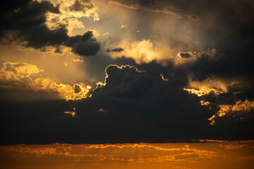 Beautiful sunset with clouds in endless fields.