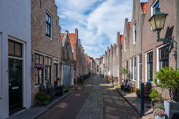 Walking in old Dutch town Zierikzee with old small houses and streets