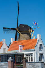 Walking in old Dutch town Zierikzee with old windmill, small houses and streets