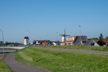 Fototapeta na wymiar View on houses and old wind mill in Wemeldinge, Zeeland, Netherlands