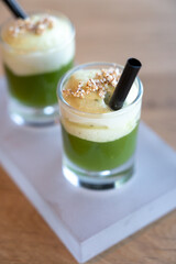 Healthy fresh cucumber mousse with whipped cream and sesame, served in glass