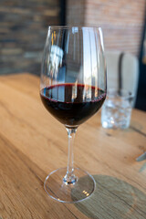 Glass of dry red wine served in cafe