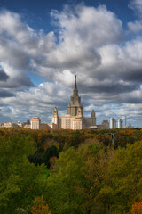 The high-rise of Moscow University main building. Summer sunlight in the blue sky with clouds. One of Stalinist skyscrapers.