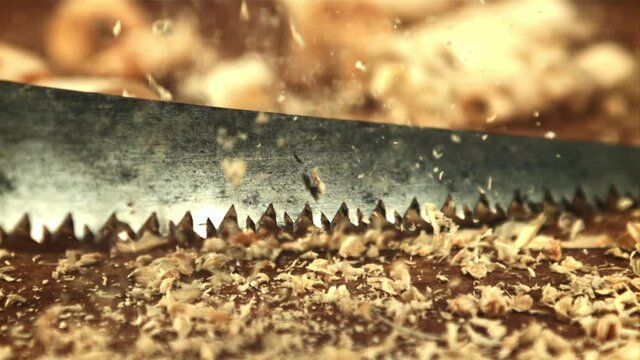 Sawdust falls on the table. On a wooden background. Filmed is slow motion 1000 frames per second.High quality FullHD footage