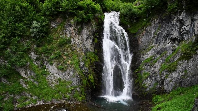 Picturesque waterfall in the mountains (Vall d'Aran, Sauth deth Pish, Spain)