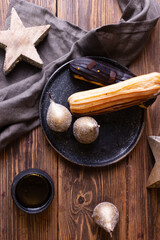 still life with eclairs on a dark background