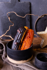 still life with eclairs on a dark background