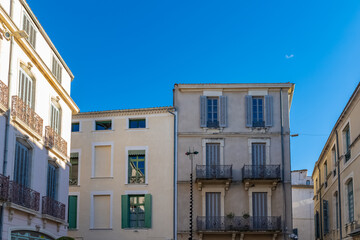 Nimes in France, old facades in the historic center, typical buildings
