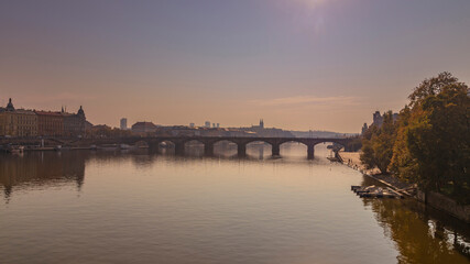 Fototapeta premium River Vltava with bridges and a boat on the surface in the city of Prague in the Czech Republic