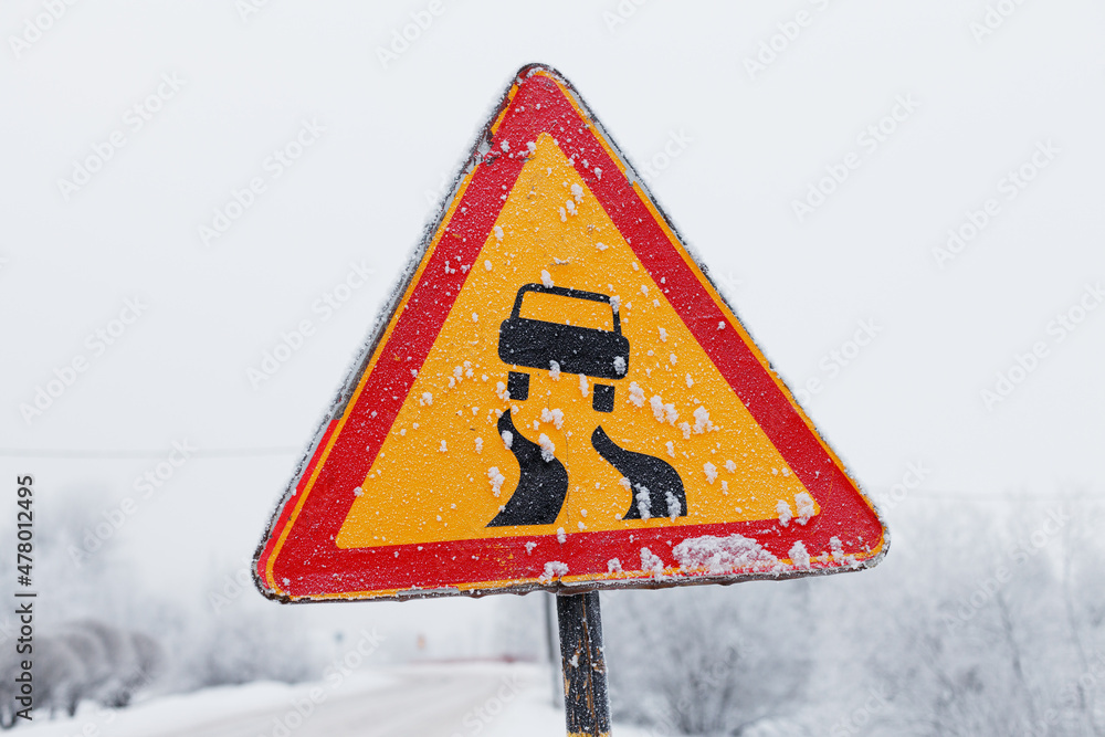 Poster road sign red triangle with a yellow field with a picture of a car and a winding road