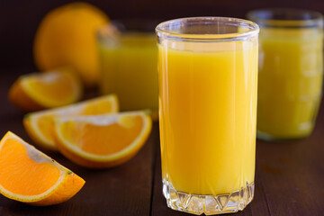 Orange juice on wooden table. Fresh summer drink