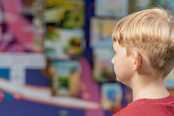 a child looks at paintings in an art gallery in the fine arts exhibition hall.