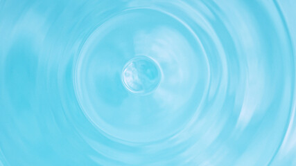 Water splash isolated on light blue background, macro shot.