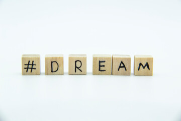 Word Dream written on the wood cubes on white  background. The concept photo with letters #dream