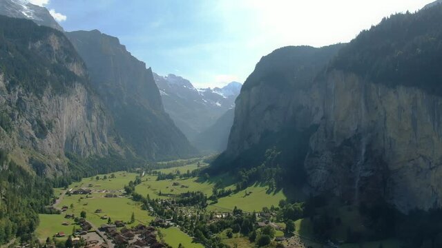 Aerial drone over the village of Lauterbrunnen and Staubbach Falls waterfall in Switzerland on a sunny day during summer 