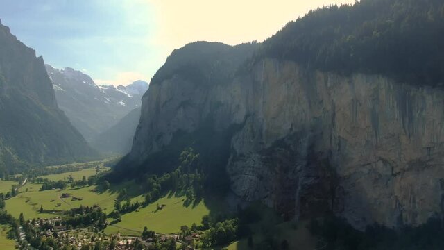 Aerial drone over the village of Lauterbrunnen and Staubbach Falls waterfall in Switzerland on a sunny day during summer 