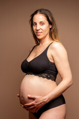 Normal pregnant woman with more than 35 years and 8 months of gestation. Black underwear.