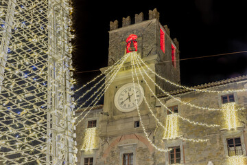 Cortona Town Hall Palace during the Christmas period with the illuminations on the clock tower.