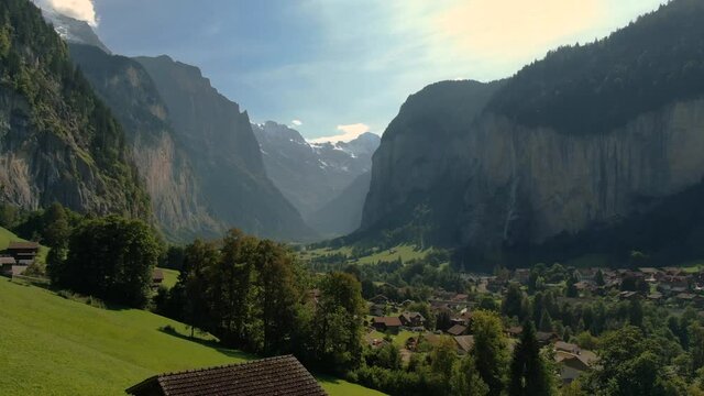 Aerial drone over the village of Lauterbrunnen and Staubbach Falls waterfall in Switzerland on a sunny day during summer 