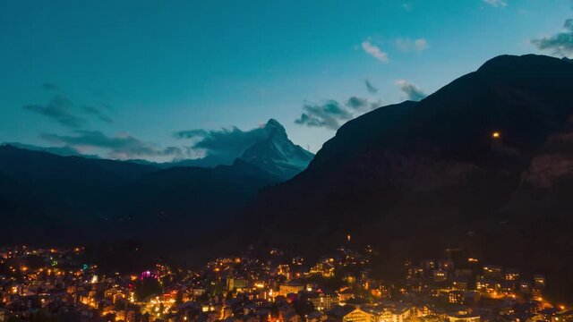 Aerial drone hyper-lapse over the famous Zermatt village with the Matterhorn peak view, in the alps in Switzerland at dusk 