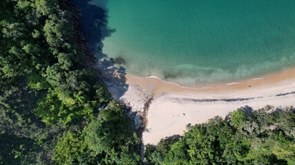 Beautiful deserted beach in Ubatuba, São Paulo, Brazil.
Atlantic forest, yellow sand and clear sea water. Figueira beach paradise.