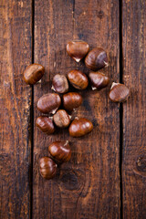 Edible chestnut on brown, top view