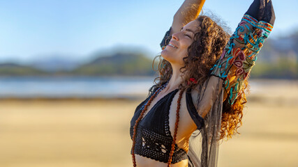 Moment of Freedom, Beautiful woman on beach with raised arms. 16:9 panoramic composition with copy space