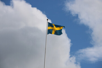 Swedish flag in the wind with the sky in the background