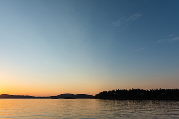Fototapeta na wymiar View from Saturna Island dock of silhouetted Southern Gulf Islands at sunset