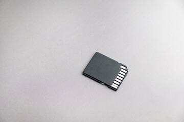 black micro sd card with gold contacts on a gray background