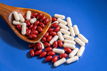Vitamin supplements on blue background