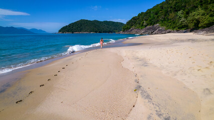 Brazilian woman in bikini on a deserted beach in Ubatuba, São Paulo, Brazil. Playing in the sea water
Atlantic forest, yellow sand and clear sea water. Figueira beach paradise.