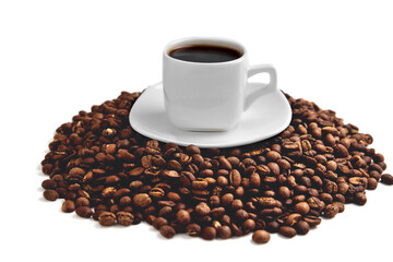 white cup of coffee on a white saucer stands on a hill of coffee beans on a white background isolate, close-up, angle view from above
